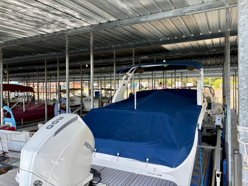 Slide: The Image of 2020 Sea Ray SDX 270 boat in covered dock. - 17