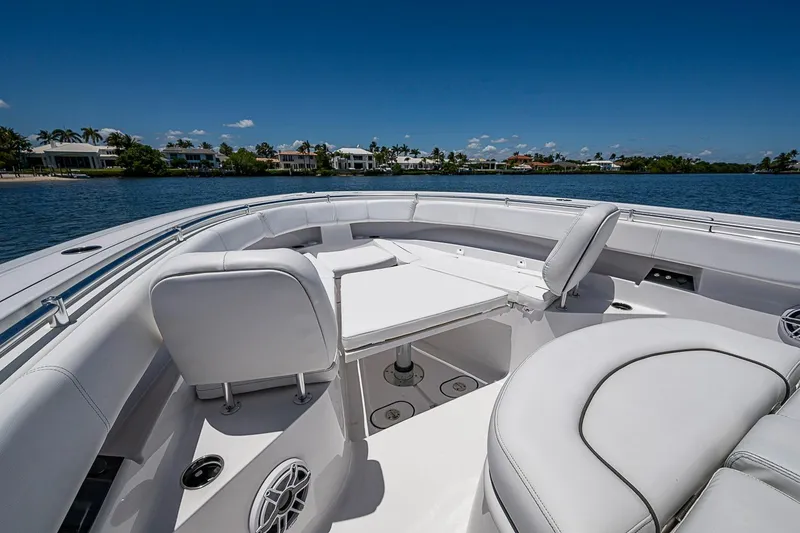 Slide: The Image of Luxurious seating area on 2023 Sportsman Open 352 Center Console boat, with waterfront view. - 11