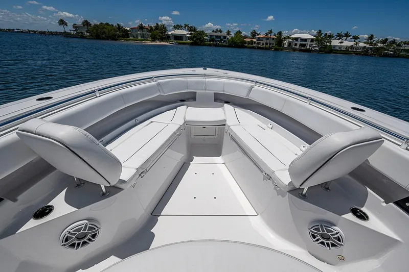 Slide: The Image of 2023 Sportsman Open 352 Center Console boat interior with white seating and ocean view. - 12