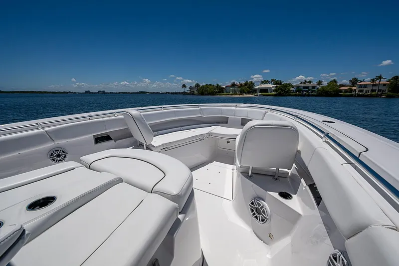 Slide: The Image of 2023 Sportsman Open 352 Center Console boat interior with luxurious seating on a sunny day. - 13