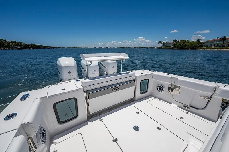 Slide: The Image of 2023 Sportsman Open 352 Center Console boat on calm water, clear sky background. - 15