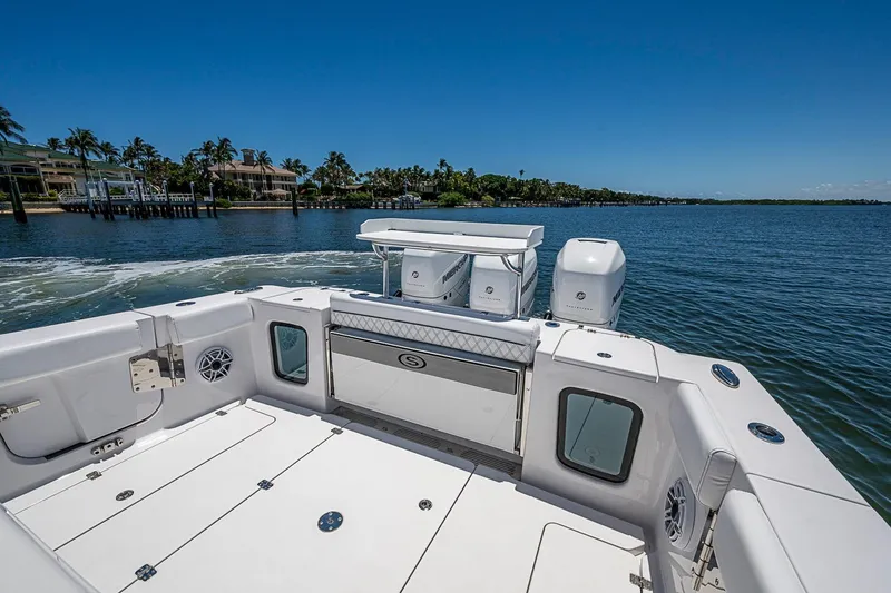 Slide: The Image of 2023 Sportsman Open 352 Center Console boat on calm water, clear sky background. - 16