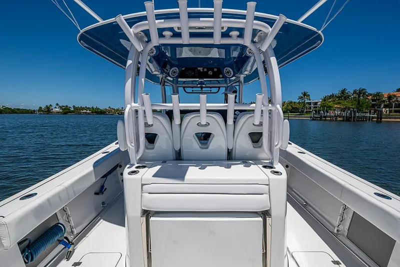 Slide: The Image of 2023 Sportsman Open 352 Center Console boat on calm water, showcasing sleek design. - 23