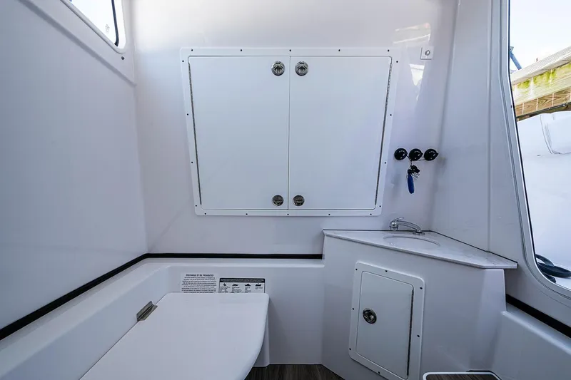 Slide: The Image of Interior of 2023 Sportsman Open 352 Center Console boat, featuring storage and sink. - 28