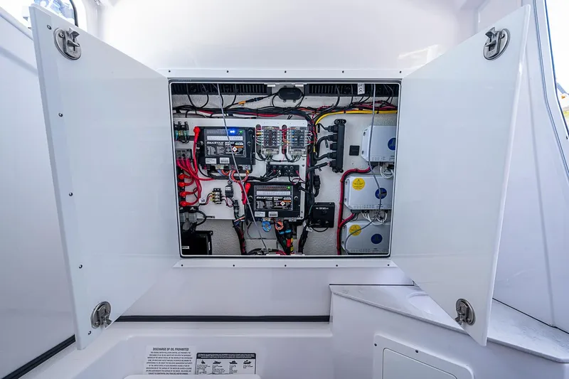 Slide: The Image of Electrical panel inside 2023 Sportsman Open 352 Center Console boat, showcasing wiring and components. - 29