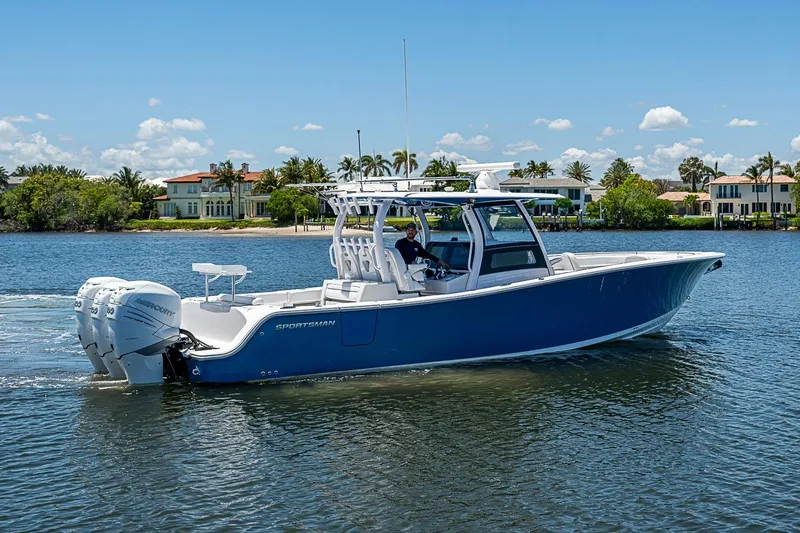Slide: The Image of 2023 Sportsman Open 352 Center Console boat cruising on a sunny day. - 3