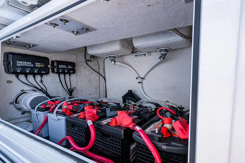 Slide: The Image of 2023 Sportsman Open 352 Center Console battery compartment with NOCO Genius chargers. - 30