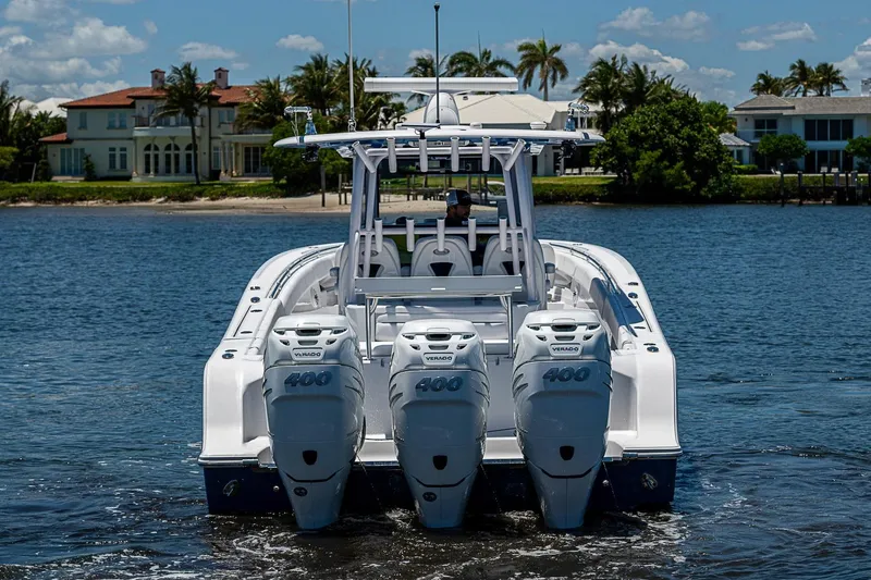Slide: The Image of 2023 Sportsman Open 352 Center Console boat with triple 400 Verado engines on water. - 4