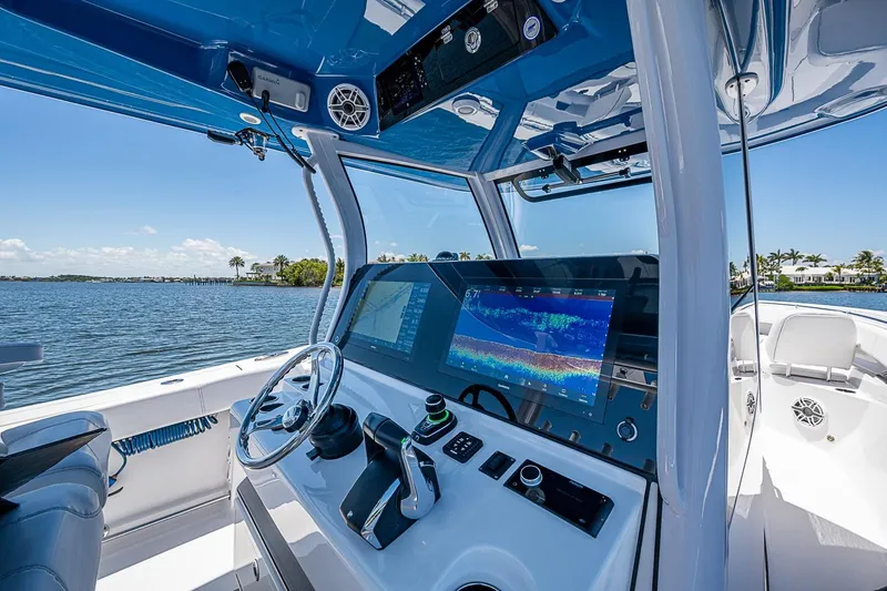 Slide: The Image of 2023 Sportsman Open 352 Center Console boat with advanced navigation system on a sunny day. - 6