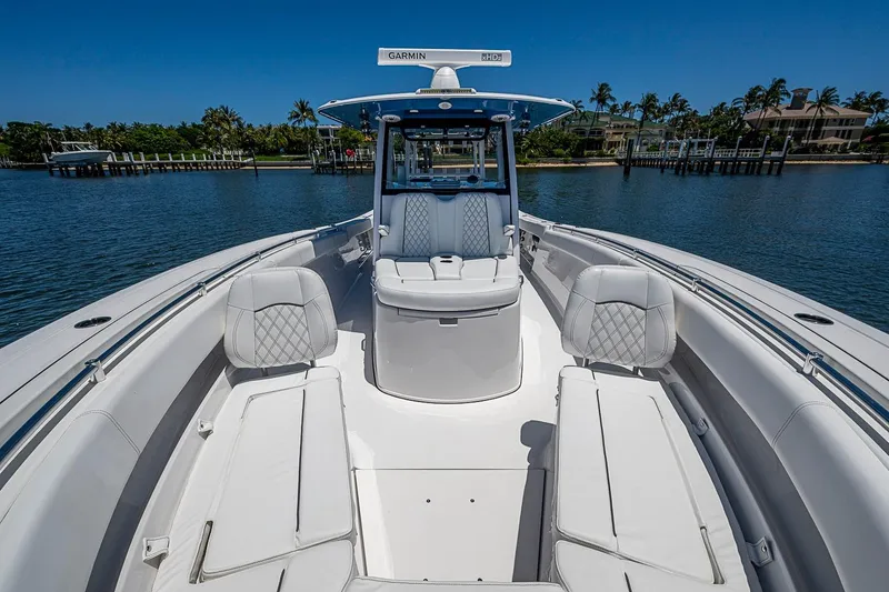 Slide: The Image of 2023 Sportsman Open 352 Center Console boat with luxurious seating on calm water. - 8