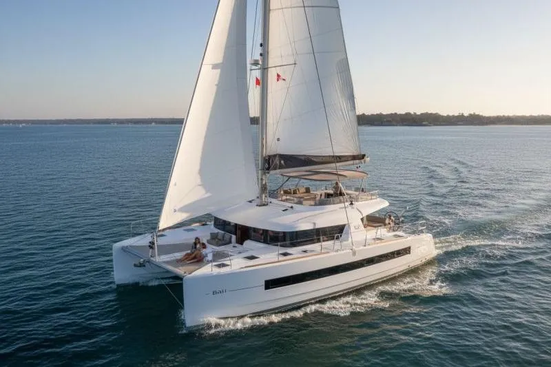 The Image of 2019 Bali 4.3 catamaran sailing on calm waters at sunset. - 0