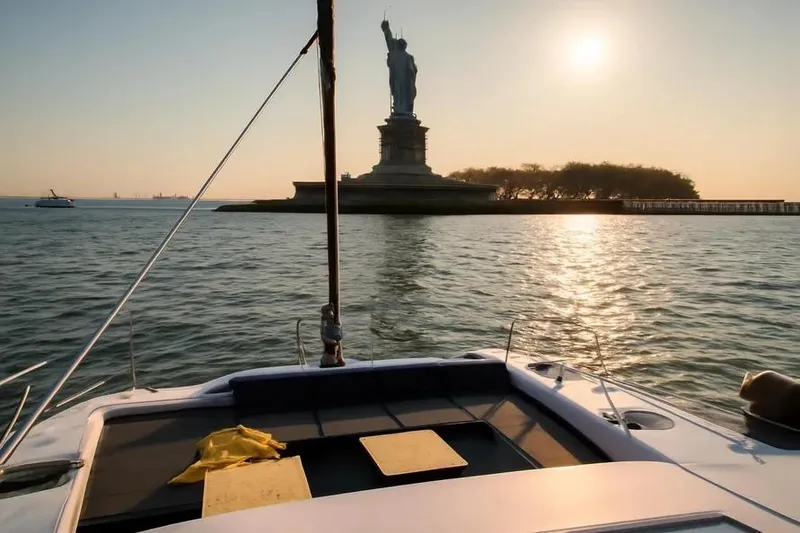 Slide: The Image of Catamaran Bali 4.3 sailing near Statue of Liberty at sunset, 2019. - 6