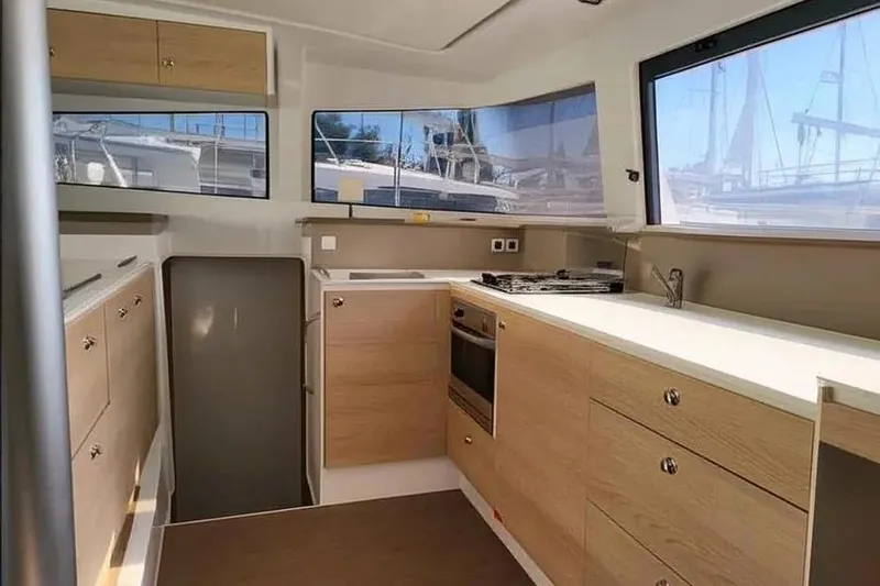 Slide: The Image of Modern kitchen interior of 2019 Bali 4.3 catamaran with wood cabinetry and large windows. - 7