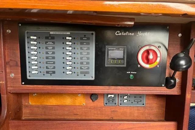 Slide: The Image of Control panel of a 1982 Catalina 38 yacht with switches and gauges. - 16