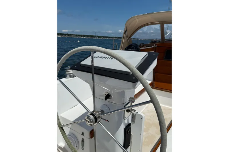 Slide: The Image of Steering wheel and Garmin navigation on 1982 Catalina 38 sailboat, docked on a sunny day. - 4