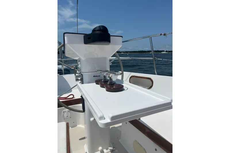 Slide: The Image of Cockpit of 1982 Catalina 38 sailboat with steering wheel and winches, under clear blue sky. - 5