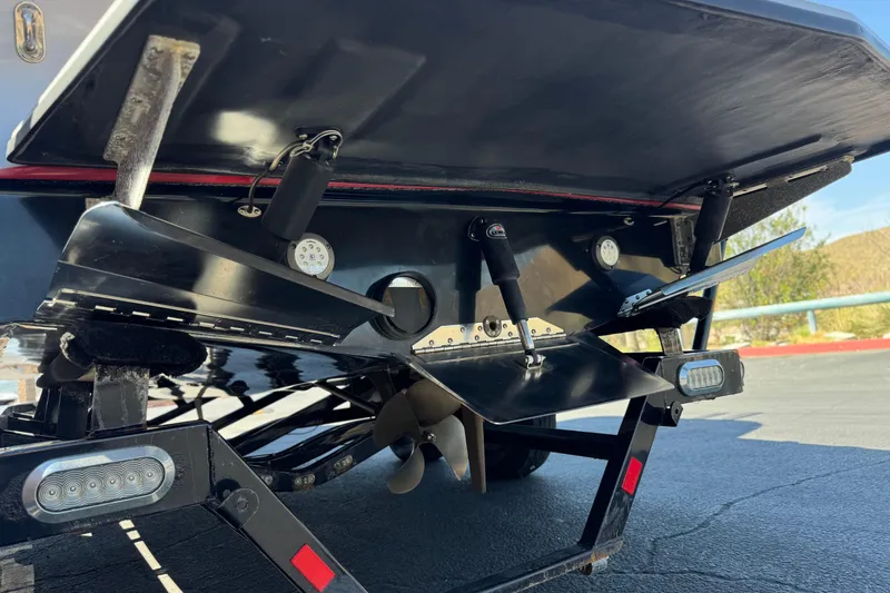 Slide: The Image of 2017 Tigé RZ2 boat underside showing propeller and trim tabs in detail. - 10