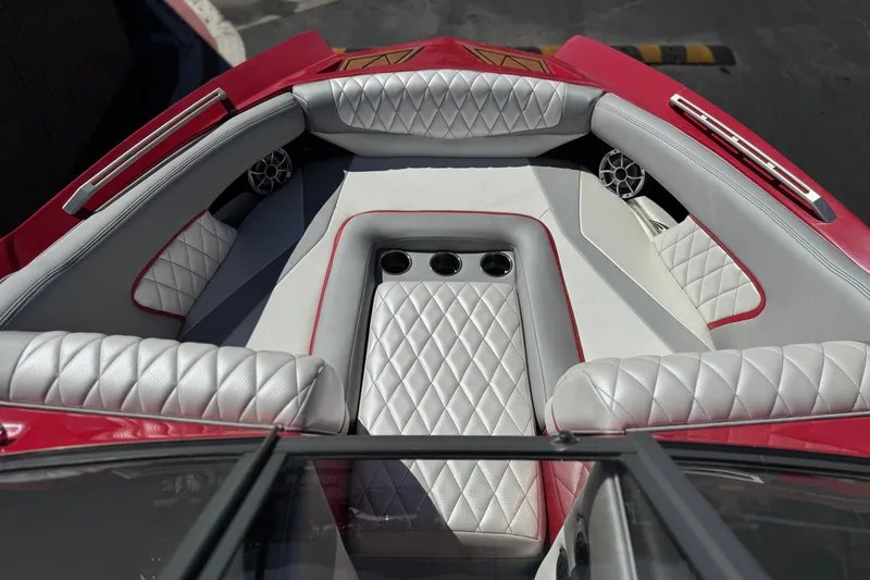 Slide: The Image of 2017 Tigé RZ2 boat interior with red and white quilted seating and cup holders. - 14
