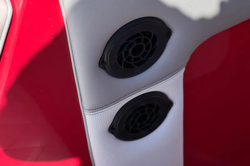 Slide: The Image of 2017 Tigé RZ2 boat interior with dual black speakers on red and white upholstery. - 19