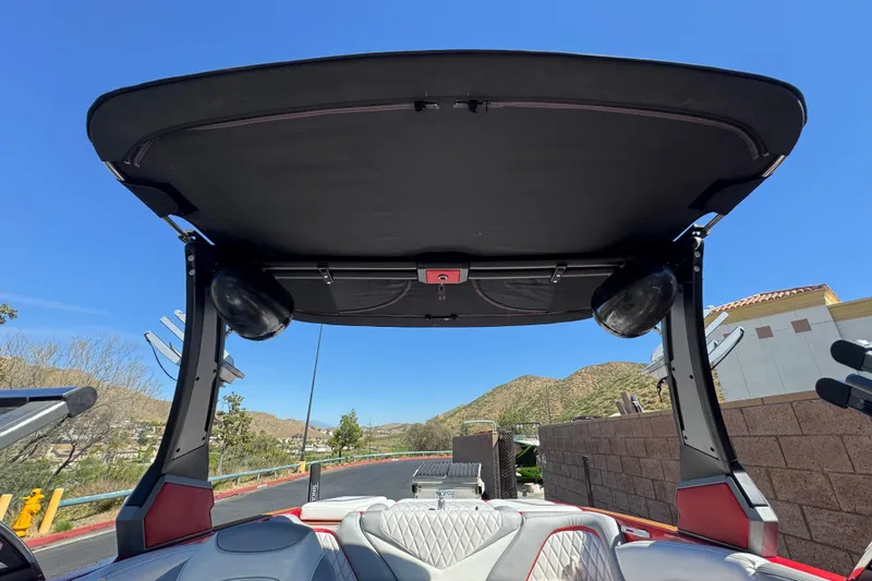 Slide: The Image of 2017 Tigé RZ2 boat interior with speakers and canopy, set against a clear blue sky. - 20