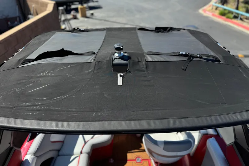 Slide: The Image of 2017 Tigé RZ2 boat with black canvas cover and visible interior seating. - 23