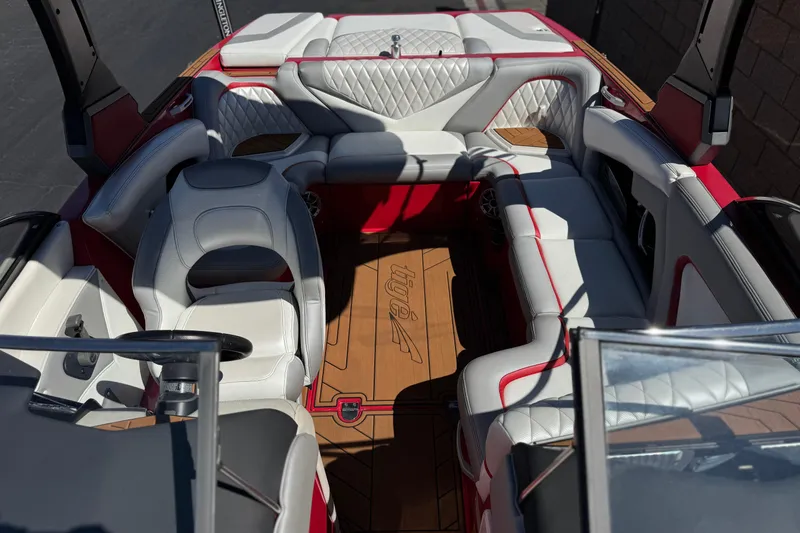 Slide: The Image of 2017 Tigé RZ2 boat interior with white and red seating, wood flooring. - 24