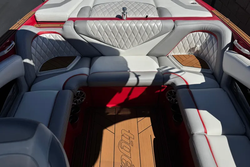 Slide: The Image of Luxurious interior of a 2017 Tigé RZ2 boat with quilted seating and wood accents. - 25
