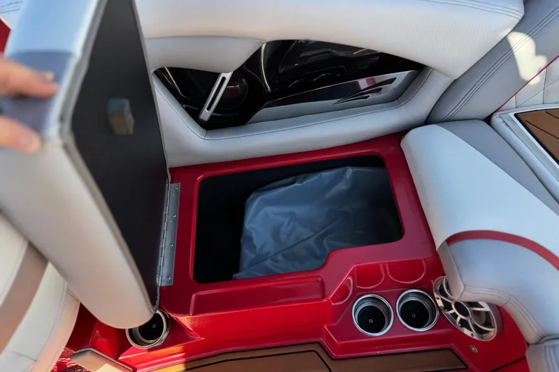 Slide: The Image of 2017 Tigé RZ2 boat interior storage compartment with cup holders and speaker. - 26