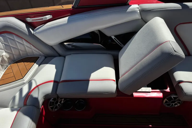 Slide: The Image of 2017 Tigé RZ2 boat interior with red accents and adjustable seating. - 27