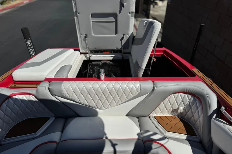 Slide: The Image of 2017 Tigé RZ2 boat interior with open engine compartment, featuring luxurious quilted seating. - 28