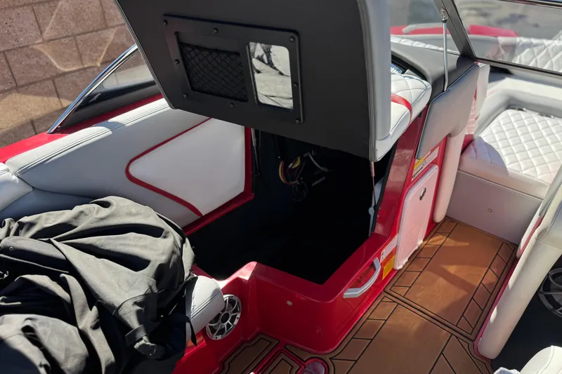 Slide: The Image of 2017 Tigé RZ2 boat interior with open storage compartment and stylish seating. - 32