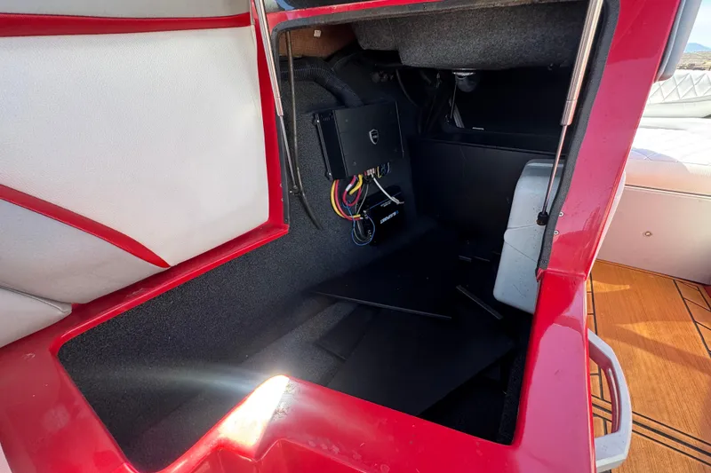 Slide: The Image of 2017 Tigé RZ2 boat storage compartment with red and white interior detailing. - 33