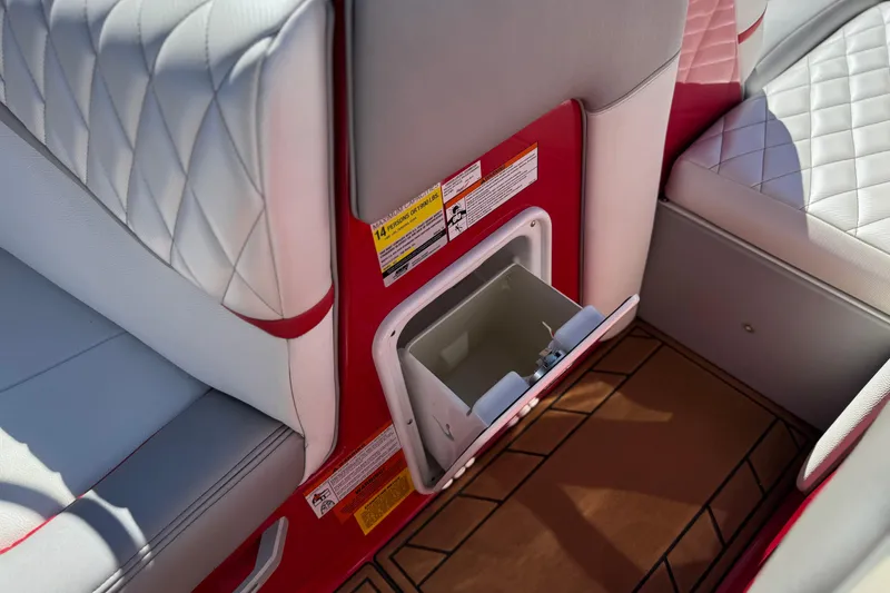 Slide: The Image of 2017 Tigé RZ2 boat interior with white quilted seats and built-in storage compartment. - 35