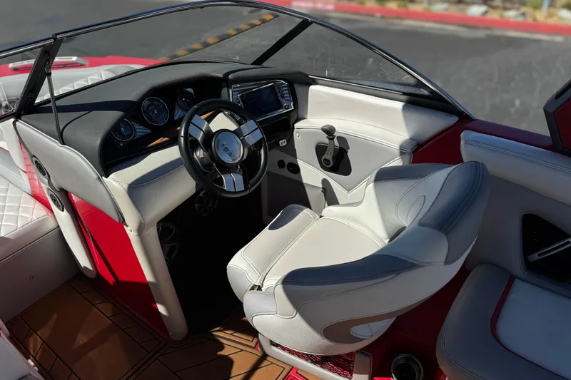 Slide: The Image of Interior of a 2017 Tigé RZ2 boat featuring a sleek steering wheel and modern dashboard. - 36