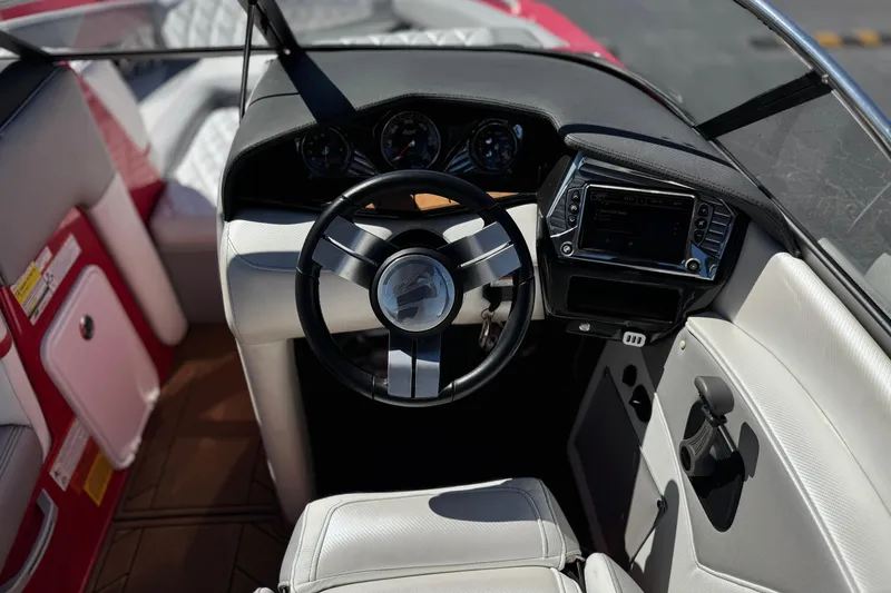 Slide: The Image of Interior of 2017 Tigé RZ2 boat showing steering wheel and dashboard controls. - 37