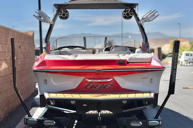 Slide: The Image of 2017 Tigé RZ2 boat with red and white design, displayed on a trailer. - 4