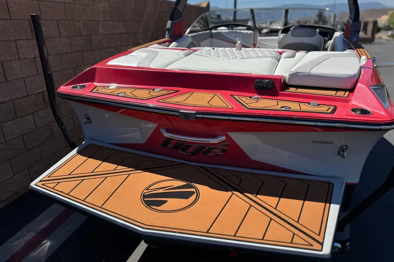 Slide: The Image of 2017 Tigé RZ2 boat with red and white design, featuring cushioned seating and teak-style decking. - 6