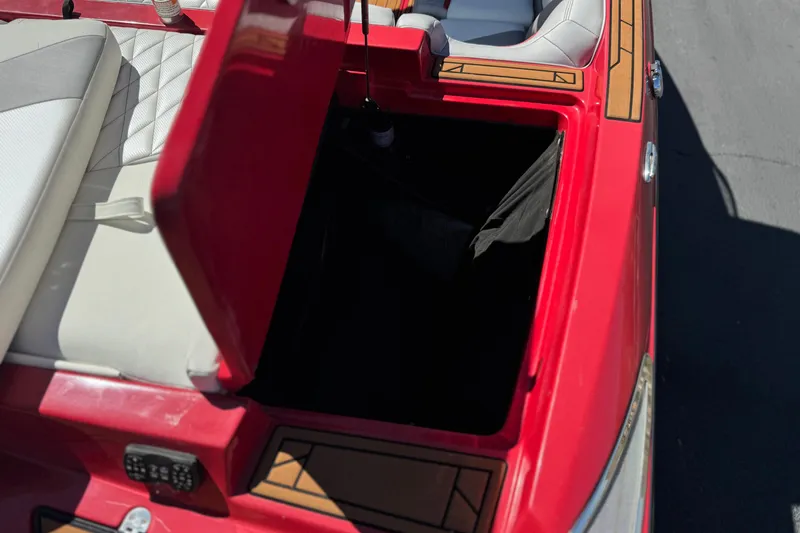 Slide: The Image of 2017 Tigé RZ2 boat with open storage compartment, red and white seating. - 9