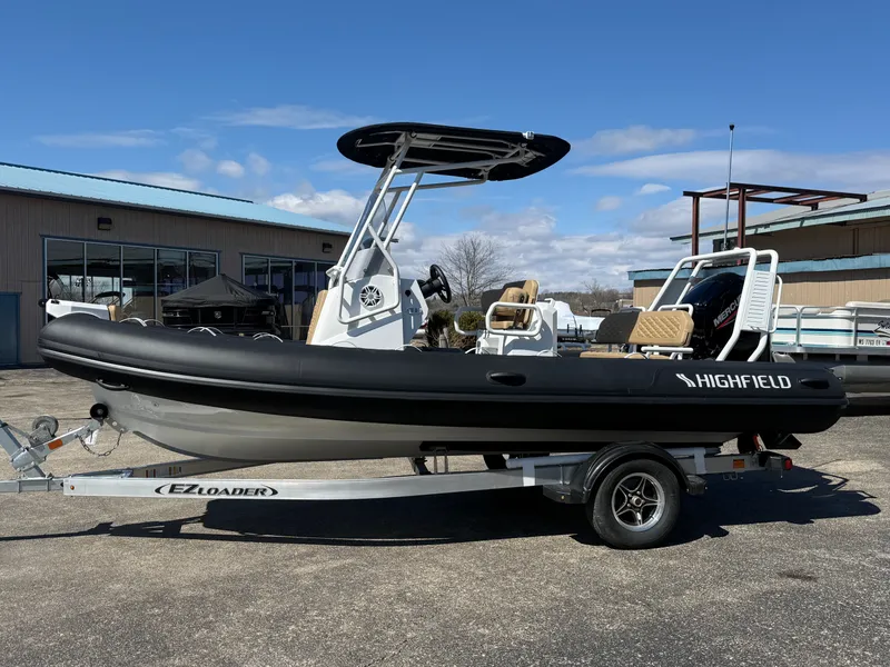The Image of 2026 Highfield Sport 560 inflatable boat on trailer outdoors. - 0