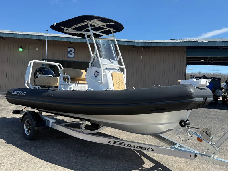 Slide: The Image of 2026 Highfield Sport 560 boat on trailer outdoors. - 2