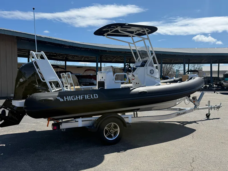 Slide: The Image of 2026 Highfield Sport 560 inflatable boat on trailer outdoors. - 3