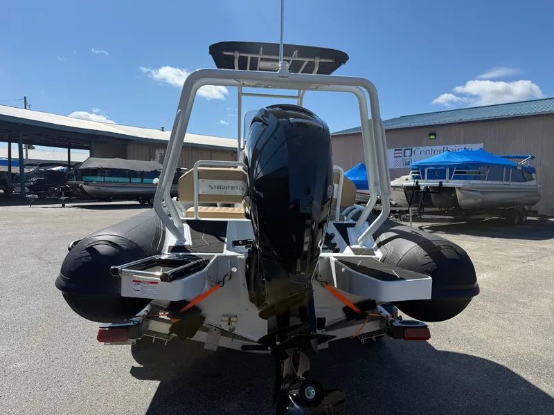 Slide: The Image of 2026 Highfield Sport 560 boat with outboard motor outdoors. - 4