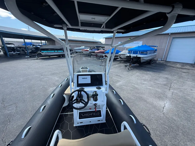 Slide: The Image of Interior view of Highfield Sport 560 boat, 2026 model, in a parking area. - 6