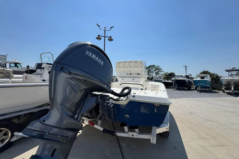 Slide: The Image of 2025 Skeeter SX221 boat with Yamaha outboard motor in a marina setting. - 11