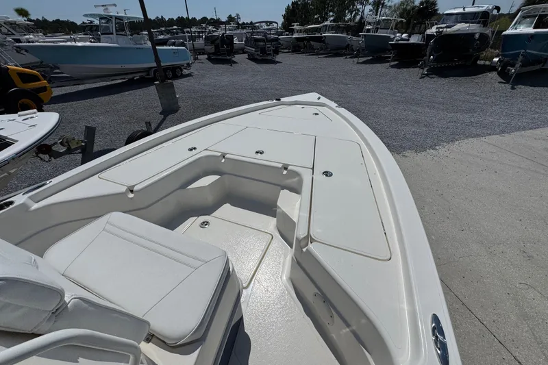 Slide: The Image of 2025 Skeeter SX221 boat deck in a marina with multiple boats. - 13