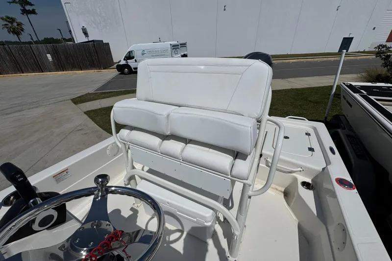 Slide: The Image of 2025 Skeeter SX221 boat interior with white seating and steering wheel. - 17