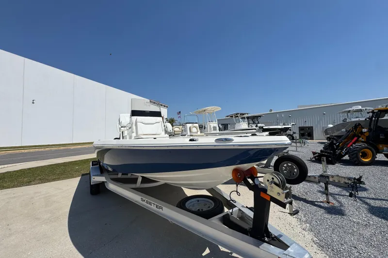 Slide: The Image of 2025 Skeeter SX221 boat on trailer in outdoor showroom. - 5