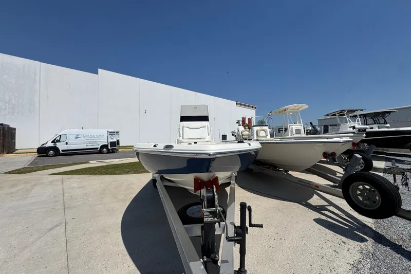 Slide: The Image of 2025 Skeeter SX221 boat on trailer in outdoor storage area. - 6