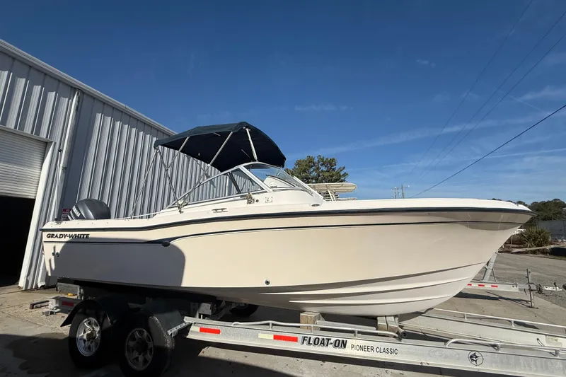 The Image of 2008 Grady-White Tournament 225 boat on trailer, parked outside metal building. - 0