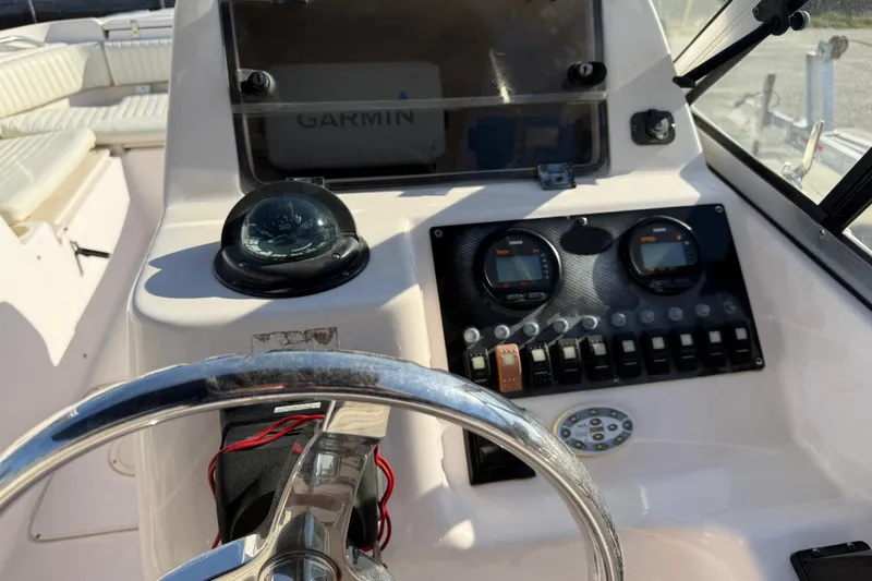 Slide: The Image of 2008 Grady-White Tournament 225 boat dashboard with Garmin navigation and steering wheel. - 6